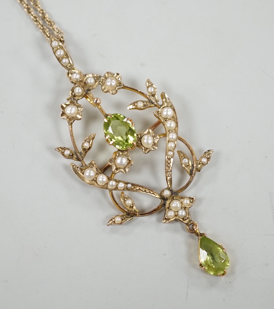 An Edwardian 9ct, peridot and seed pearl set drop pendant brooch, 57mm, on a later 375 rope twist chain, 44cm gross weight 6.7 grams.